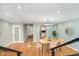 Open-concept living space with dining area, open stairwell, and modern lighting at 8061 Lower Bay Ln # 1, Indianapolis, IN 46236