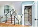 Modern staircase with wood and tile risers, cable railings, and an adjacent residential elevator at 8061 Lower Bay Ln # 1, Indianapolis, IN 46236