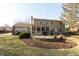 The backyard has a nice patio with a stone fire pit and mature landscaping at 9080 Dewberry Ct, Indianapolis, IN 46260