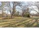 Lush backyard with mature trees and a charming fire pit area at 9080 Dewberry Ct, Indianapolis, IN 46260