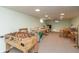 Spacious basement with tile flooring, game tables, and ample room for activities at 9080 Dewberry Ct, Indianapolis, IN 46260