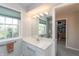 This bathroom features a sleek vanity with modern lighting and a view into the closet at 9080 Dewberry Ct, Indianapolis, IN 46260