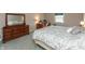 Primary bedroom featuring a wooden dresser and a sunny window at 9080 Dewberry Ct, Indianapolis, IN 46260