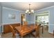Well-lit dining room featuring a classic wood table, buffet, and seamless transition to living spaces at 9080 Dewberry Ct, Indianapolis, IN 46260