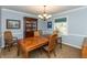 Traditional dining room featuring a wood table, elegant chandelier, and blue accent wall at 9080 Dewberry Ct, Indianapolis, IN 46260