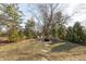 Backyard view featuring a stone fire pit with seating, perfect for outdoor gatherings at 9080 Dewberry Ct, Indianapolis, IN 46260
