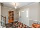Bright entryway with slate flooring, white wainscoting, and stairs leading to the second floor at 9080 Dewberry Ct, Indianapolis, IN 46260