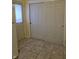 Hallway featuring a large storage closet with sliding doors and neutral tile flooring at 9080 Dewberry Ct, Indianapolis, IN 46260