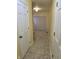 Hallway with tan tile floors, door frames, and a glimpse into another room at 9080 Dewberry Ct, Indianapolis, IN 46260
