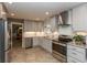 Modern kitchen featuring stainless steel appliances, sleek cabinetry, and easy access to the dining area at 9080 Dewberry Ct, Indianapolis, IN 46260