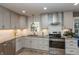 Bright kitchen boasts stainless steel appliances, granite countertops, and white subway tile backsplash at 9080 Dewberry Ct, Indianapolis, IN 46260
