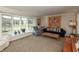 Cozy living room featuring large windows, a decorative quilt, and comfortable furniture at 9080 Dewberry Ct, Indianapolis, IN 46260