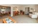 Spacious living room with neutral carpet, ample seating, and seamless transitions to dining and entry areas at 9080 Dewberry Ct, Indianapolis, IN 46260