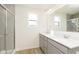 Bathroom featuring double sink vanity, large mirror, and walk-in shower at 9730 Behner Dr, Fishers, IN 46250