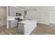 Well-lit kitchen showcasing stainless appliances, gray cabinets, and a white countertop island at 9730 Behner Dr, Fishers, IN 46250