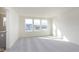 Bright living room with carpet, and three large windows overlooking the community at 9730 Behner Dr, Fishers, IN 46250