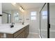 Bright bathroom with double sinks, sleek fixtures, and a glass-enclosed shower at 9742 Behner Dr, Fishers, IN 46250
