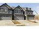 Modern townhome exterior showcasing neutral color palette and attached two car garage in a new construction community at 9742 Behner Dr, Fishers, IN 46250
