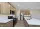Modern kitchen with stainless steel appliances, a kitchen island with white countertop, and light wood cabinetry at 9742 Behner Dr, Fishers, IN 46250