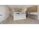 Open-concept kitchen with a large island, stainless steel appliances, and views of the entryway and living area at 9742 Behner Dr, Fishers, IN 46250