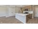 Kitchen island with white countertops, a black faucet, and stainless steel appliances in an open-concept layout at 9742 Behner Dr, Fishers, IN 46250