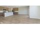Open concept living space with wood flooring, seamless flow between the kitchen, dining, and living areas at 9742 Behner Dr, Fishers, IN 46250
