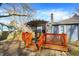 Back patio has a seating area with a pergola cover and a bright-orange decorative railing at 1195 W Edgewood Ave, Indianapolis, IN 46217