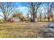 Large backyard with a play set, storage shed, and mature trees at 1195 W Edgewood Ave, Indianapolis, IN 46217