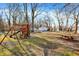 Expansive backyard featuring a playground, picnic table, and detached garage at 1195 W Edgewood Ave, Indianapolis, IN 46217