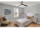 Cozy bedroom features a ceiling fan and a brightly decorated chair at 1195 W Edgewood Ave, Indianapolis, IN 46217