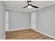 The bedroom has a ceiling fan, light hardwood floors, fresh light-grey paint and white trim at 1195 W Edgewood Ave, Indianapolis, IN 46217