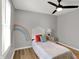 Bedroom with ceiling fan, a nightstand, and a colorful wall decoration at 1195 W Edgewood Ave, Indianapolis, IN 46217