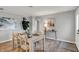 Dining area with table set for four, flowing into other living spaces at 1195 W Edgewood Ave, Indianapolis, IN 46217