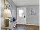 Bright entryway with decorative front door, table with lamp, and hardwood floors at 1195 W Edgewood Ave, Indianapolis, IN 46217