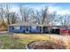 Charming single-story home with blue siding, landscaped yard, and carport at 1195 W Edgewood Ave, Indianapolis, IN 46217