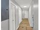 Hallway with several storage closets and wood-look flooring at 1195 W Edgewood Ave, Indianapolis, IN 46217