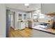 Bright kitchen with white cabinetry, wood countertops, and stainless steel appliances at 1195 W Edgewood Ave, Indianapolis, IN 46217