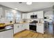 Kitchen with white cabinets, stainless steel appliances, and a wooden countertop at 1195 W Edgewood Ave, Indianapolis, IN 46217