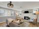 Bright living room showcasing a brick fireplace, windows, and modern decor at 1195 W Edgewood Ave, Indianapolis, IN 46217