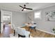 Well-lit home office featuring a modern desk, stylish chairs, and hardwood floors at 1195 W Edgewood Ave, Indianapolis, IN 46217