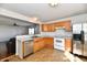 Functional kitchen with stainless steel dishwasher, oven, refrigerator, and wood cabinets at 120 White Lick Dr, Indianapolis, IN 46227