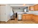 Practical kitchen with a stainless steel dishwasher, double sink, and oak cabinets at 120 White Lick Dr, Indianapolis, IN 46227