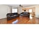 Spacious living room featuring hardwood floors, a ceiling fan, and a view into kitchen at 120 White Lick Dr, Indianapolis, IN 46227