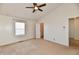 Sunlit main bedroom with vaulted ceilings, a ceiling fan, and neutral carpeting at 120 White Lick Dr, Indianapolis, IN 46227