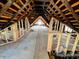 Spacious unfinished attic featuring exposed rafters, wooden framing and natural light at 120 Wisconsin St, Indianapolis, IN 46225