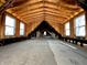 Attic view of a building featuring exposed rafters and natural light at 120 Wisconsin St, Indianapolis, IN 46225