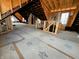 Interior shot with exposed framing, rafters, and temporary floor covering at 120 Wisconsin St, Indianapolis, IN 46225