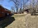 Brick home with spacious backyard, featuring a shed and mature trees at 1410 E 8Th St, Anderson, IN 46012
