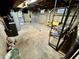 Unfinished basement with concrete walls and floors, storage, and utility equipment at 1410 E 8Th St, Anderson, IN 46012