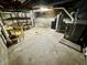 Unfinished basement with concrete walls and floors, storage, and utility equipment at 1410 E 8Th St, Anderson, IN 46012